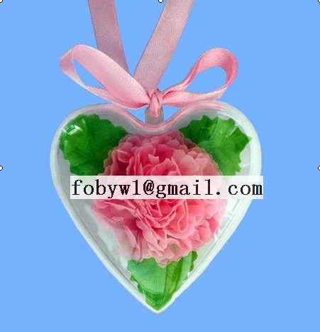 carnation and leaves in a plastic heart box with r